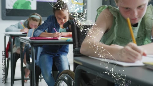 Wheelchair student writing while net forming and sweeping left hitting wheel and arm, showing class
