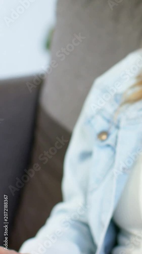 Vertical video: Holding lady tapping tab case on lap at home as cam panning jean jacket, copy space