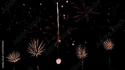  loop seamless of real fireworks background golden shining fireworks with bokeh lights in the night sky. glowing fireworks show. New year's eve fireworks celebration multiple colors 
