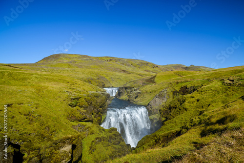 Waterfall on the Skoga river below green hills