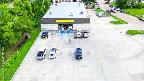 Aerial view of a convenience store parking lot with cars parked in front of the building