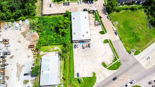 Aerial view of a commercial warehouse building with a large parking lot and surrounding grounds