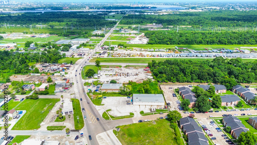 Aerial view of a suburban landscape with roads, residential buildings, and industrial areas