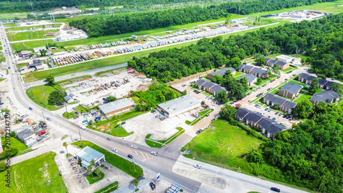 Aerial view of a commercial and residential area with a large parking lot