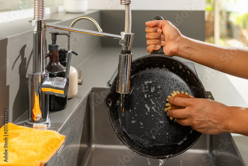Fotografie Eco friendly kitchen cleaning with cast iron skillet and natural dish soap