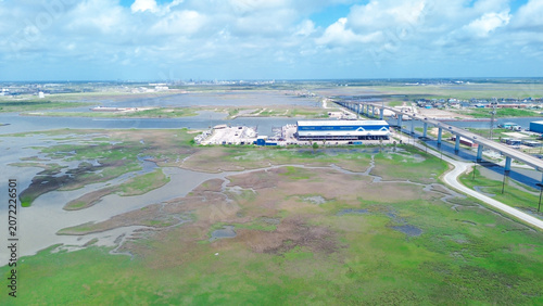 Принти на полотні Modern marine storage facility sits adjacent to bridge infrastructure