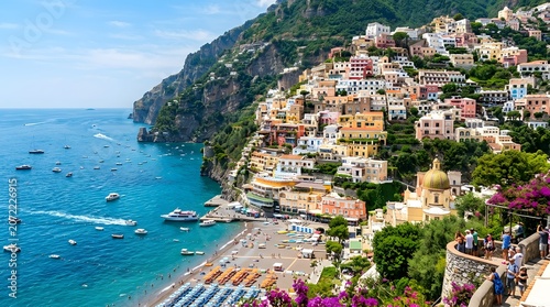 Positano, Italy: A picturesque Italian coastal village with colorful houses clinging to a steep cliffside overlooking the azure Mediterranean Sea. People relax on the beach, boats dot the water.