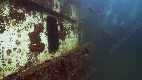 Scuba Divers Exploring the Sunken Ocean Winds Tugboat Shipwreck Underwater