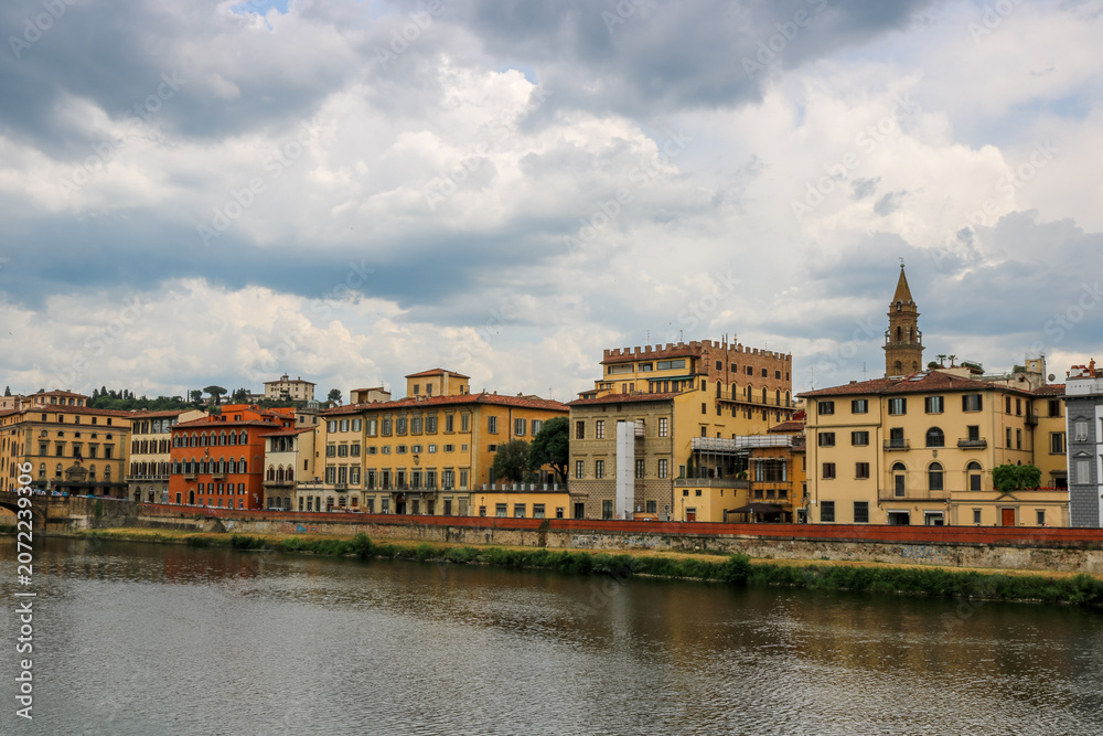 Fototapeta premium Famous historic Ponte Vecchio bridge and old buildings along the Arno river in Florence Italy