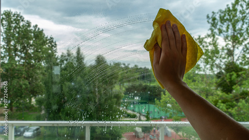 Cleaning Window Glass With Yellow Microfiber Cloth at Home