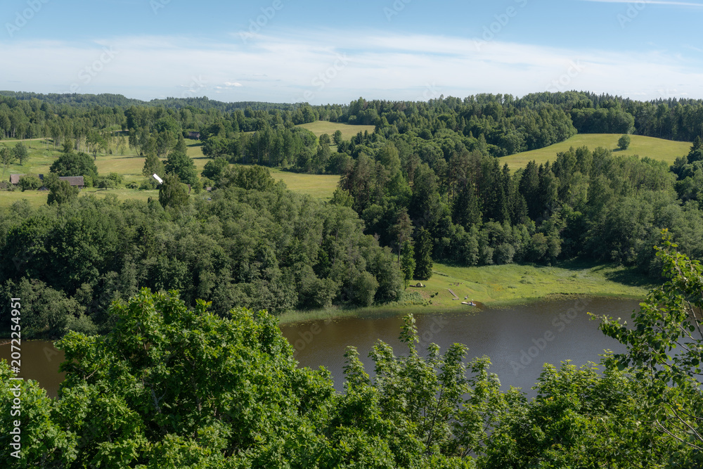 Obraz premium Rural Lake Valley with Forest, Meadows and Farmland for Nature Tourism and Land Management