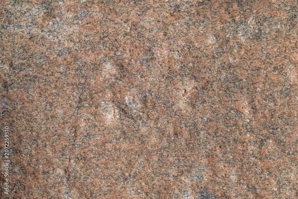 Fototapeta premium Stone texture. Detailed texture of natural pink granite stone surface close up.