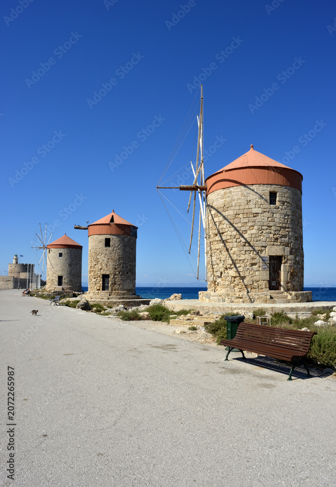 Fototapeta premium Historical windmills at the harbour in Rhodes, Greece