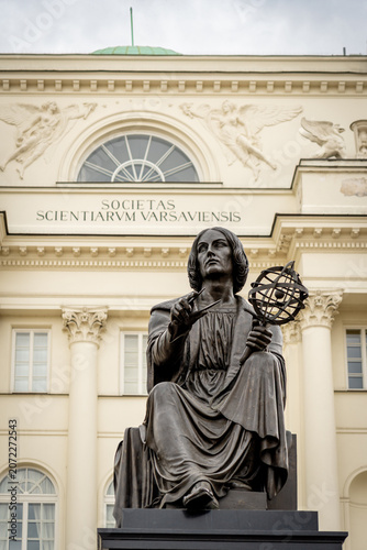 Copernicus statue in Warsaw with armillary sphere before neoclassical facade and grand columns pride