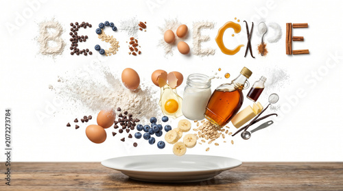 Levitating multi layered Pancakes and BEST RECIPE text made of organic ingredients above a plate, conceptual food photography on white background