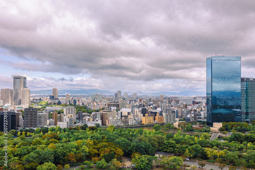 Obraz premium Viewing business district with contemporary architecture and layered cityscape in daylight, Osaka, Japan
