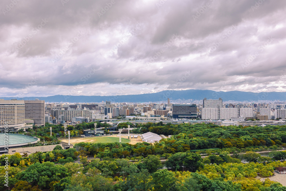 Fototapeta premium Viewing business district with contemporary architecture and layered cityscape in daylight, Osaka, Japan