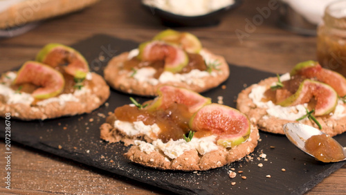 Photos Whole-grain crispbreads topped with cream cheese, fig jam, and fresh figs
