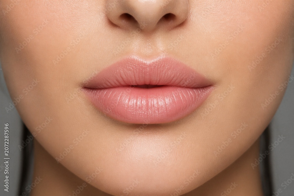 Obraz premium Female lips relaxed in studio close up portrait lighting soft