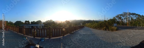 Panoramic view of mountain road at sunset with motorcycle outdoor recreation