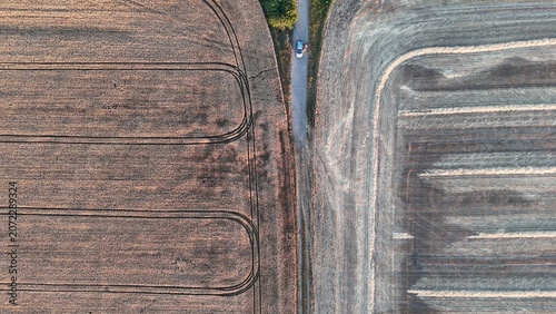 Canvas Print Drone view of harvested wheat fields at sunset near Baracs