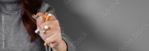 Fotografie Conceptual image of quitting smoking by crushing a cigarette in a clenched fist, symbolizing strength, determination, breaking addiction, and commitment to a smoke-free lifestyle