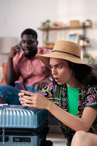 Canvastavla Woman receiving shocking news about travel tickets on phone