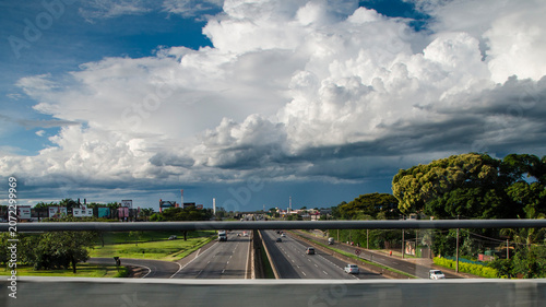 Konstfotografi Dramatic Clouds Over a City Avenue from an Overpass