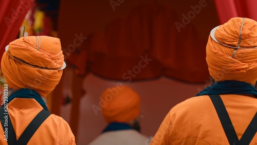Indian guards of the Sikh religion sacred text in chariot during Vaisakhi fest