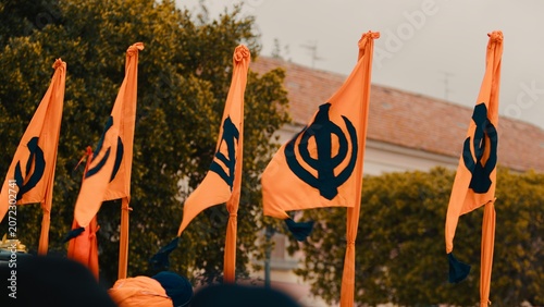 Flags symbolizing the Indian Sikh religion wave during the Vaisakhi parade