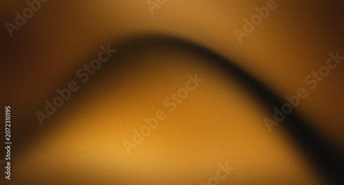 A smooth transition between dark brown, muted orange, ochre, and cream, overlaid with an effect of fine, intense speckles that evoke an analog aesthetic, a tactile feel, or a paper texture.