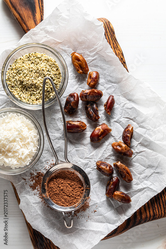 Ingredients on a parchment covered cutting board to make energy balls.