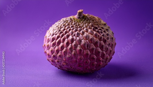 Isolated Tropical Fruit On Purple A Close Up Shot Features A Ripe Round Tropical Fruit Positioned Against A Solid Vibrant Purple Background The Fruit S Texture And Natural Colors Stand Out