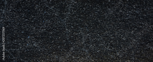Fényképezés Polished black granite texture background, dark natural stone surface with cryst