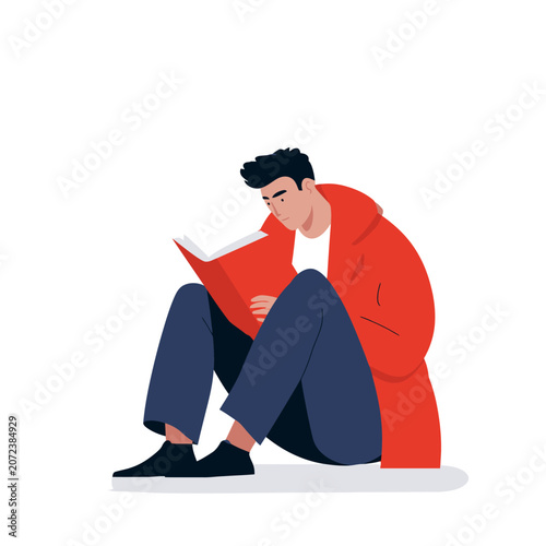 Young student intently reading an open book while sitting