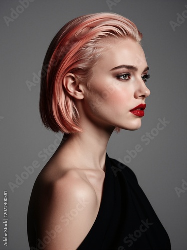 Fashion Portrait of a Beautiful Young Woman with Pink Short Hair and Bold Red Lipstick