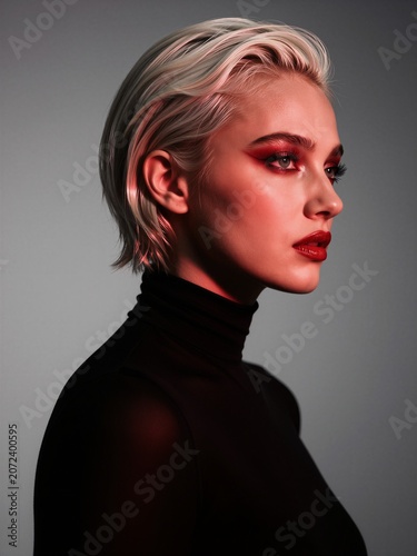 High Fashion Portrait of a Young Woman with Bold Red Makeup and Platinum Blonde Hair