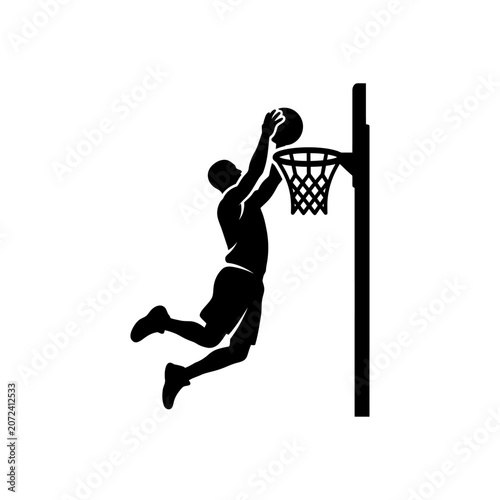 Black silhouette of a basketball player dunking a ball into a hoop isolated on white background