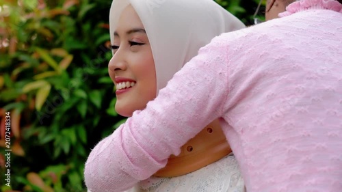 A young Asian Muslim woman wearing a Cervical Collar. Neck injury.