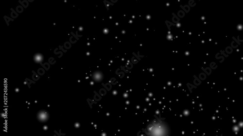 Snow overly on black background, Particles float in a dark space creating a soft bokeh effect of light.