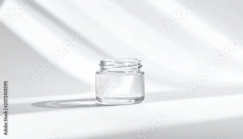 Small empty glass jar on white.