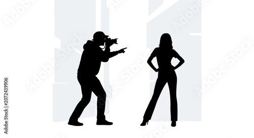 Silhouette of a professional photographer taking a picture of a female model.