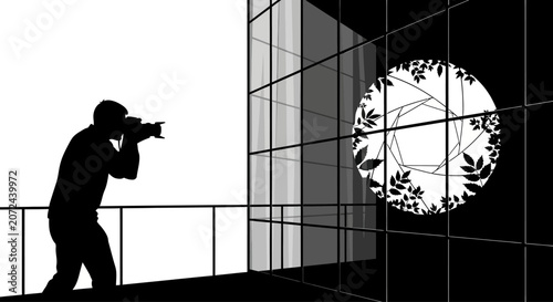 A silhouette of a photographer capturing a circular floral aperture design.