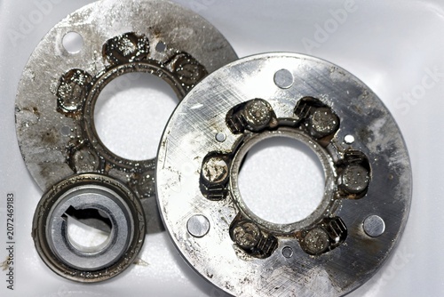 Disassembled e-bike motor sprag clutch with old worn grease on metal gears and metallic bearings, essential internal mechanical parts for electric bicycle hub motor repair and maintenance