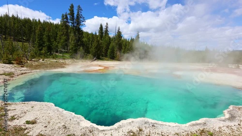 Steam rises above the crystal blue waters of Abyss Pool in Yellowstone National Park