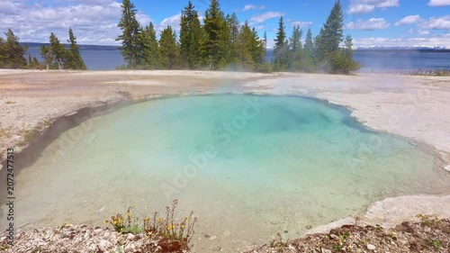 Steaming geothermal features line the shore of Yellowstone Lake in Yellowstone National Park