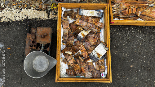 Photos Top down view of traditional salted fish or smoked fish displayed in a wooden bo