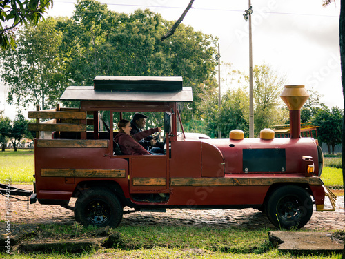 Small red toy train sits on grass