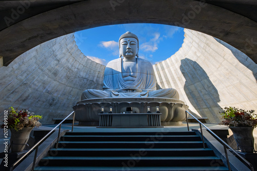 Sapporo, Japan - October 30 2025: Makomanai Takino Cemetery is a vast greenspace features a collection of 40 Moai head, a Stonehenge replica and a giant Buddha statue.