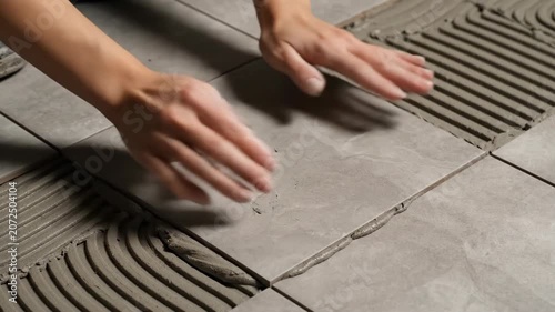 Installing Floor Tiles with Precision and Care for a Smooth Finish.